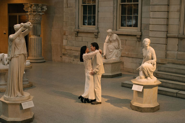 Couple portrait among sculptures at Metropolitan Museum of Art New York City