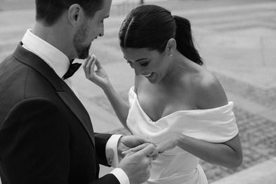 Black-and-white close-up of groom whispering to bride, intimate moment during NYC elopement at the New York Public Library