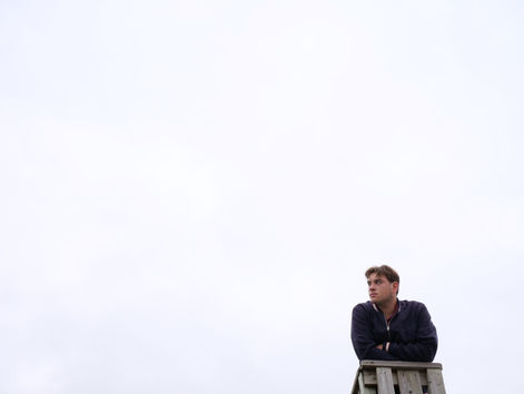 Nick is framed by a white sky