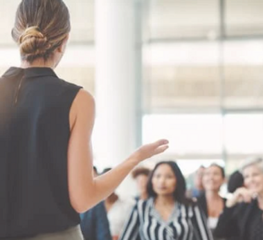 woman giving a lecture to people