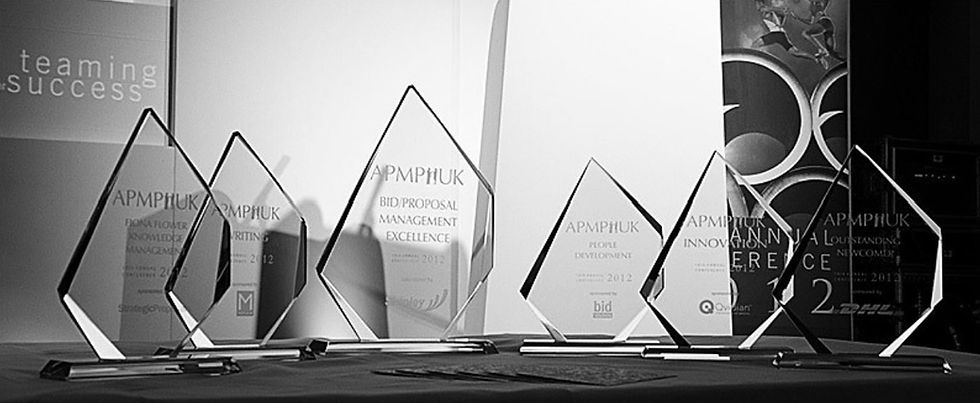 APMP UK Award Trophies lined up on a table
