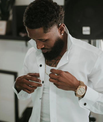 Custom look, man putting his shirt on from a touch of class