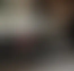 Professional chauffeur opening the door of a luxury black sedan for a client outside a modern hotel, representing reliable Alpharetta Airport limo service with premium executive transportation.