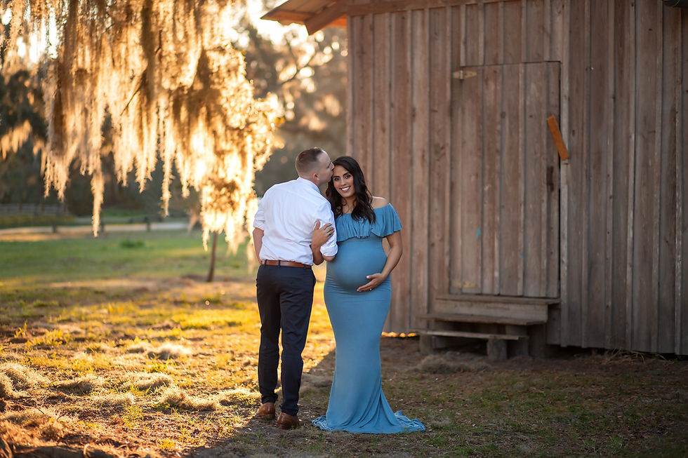 Pregnant mother wearing blue flowy gown in Tampa