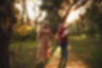 Mother and father holding baby girl during their sunset photo session