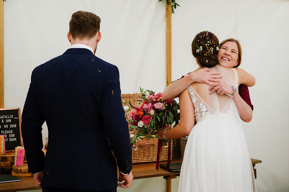 After the boho style wedding celebration ceremony, the bride is hugging the celebrant to say thank you