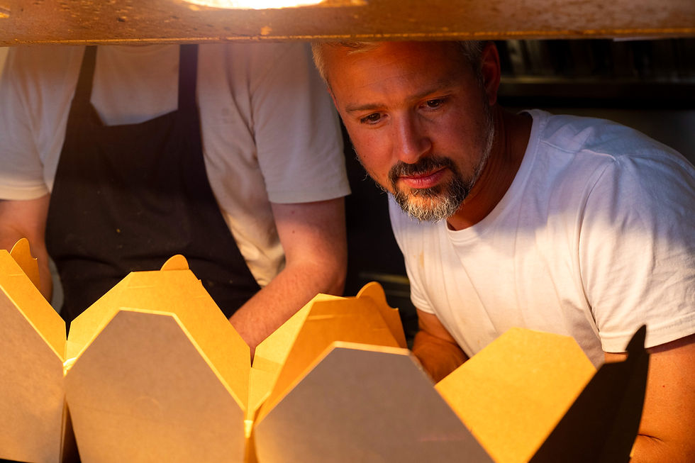 James Larman preparing boxes of food for an outside event at Bohemia in St Neots.