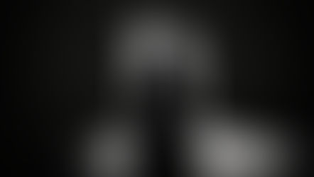 A VCUG survivor sitting across from a mirror, reflecting on healing journey.