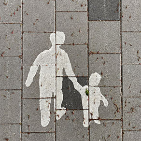 A chalk outline of a parent leading their young child by the hand.