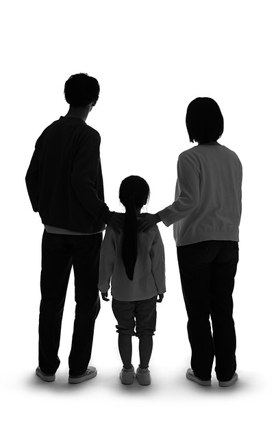 Silhouette of standing little girl and parents rear view..jpg