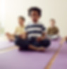 Group of children practicing breathing exercises in a yoga class, focusing on Pranamaya Kosha and physiological health.