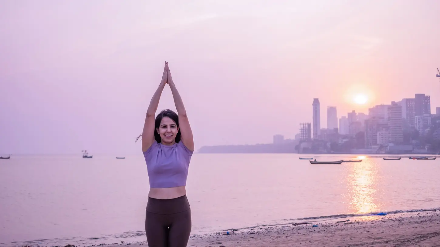 A serene yoga instructor in mountain pose at sunset, symbolizing grounding, balance, and mindfulness — perfect for promoting the benefits of yoga for both kids and adults.