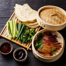 Peking duck meal with pancakes, cucumber, and sauces. Asian Supplies