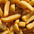 Close-up shot of golden, crispy french fries, a popular fried food.