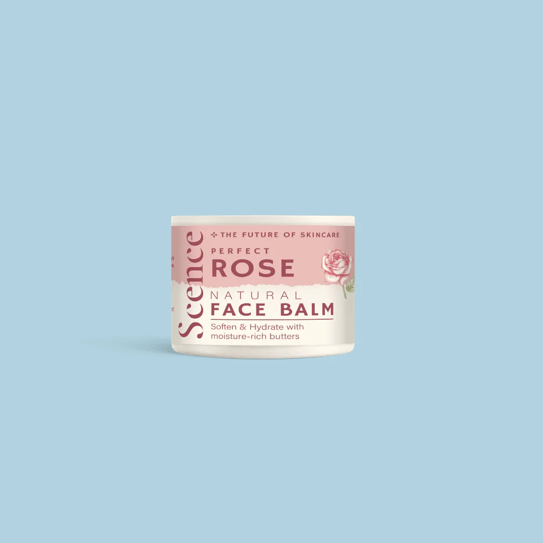 A tub of Scence Perfect Rose Natural Face Balm in pale pink packaging on a baby blue background.