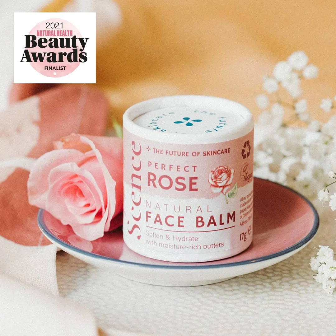 Tub of Scence Perfect Rose Natural Face Balm in pale pink packaging, sitting on a small decorative plate with a pink rose next to it and flowers in te background. A banner on the photo reads 2021 Natural health Beauty Awards Finalist.