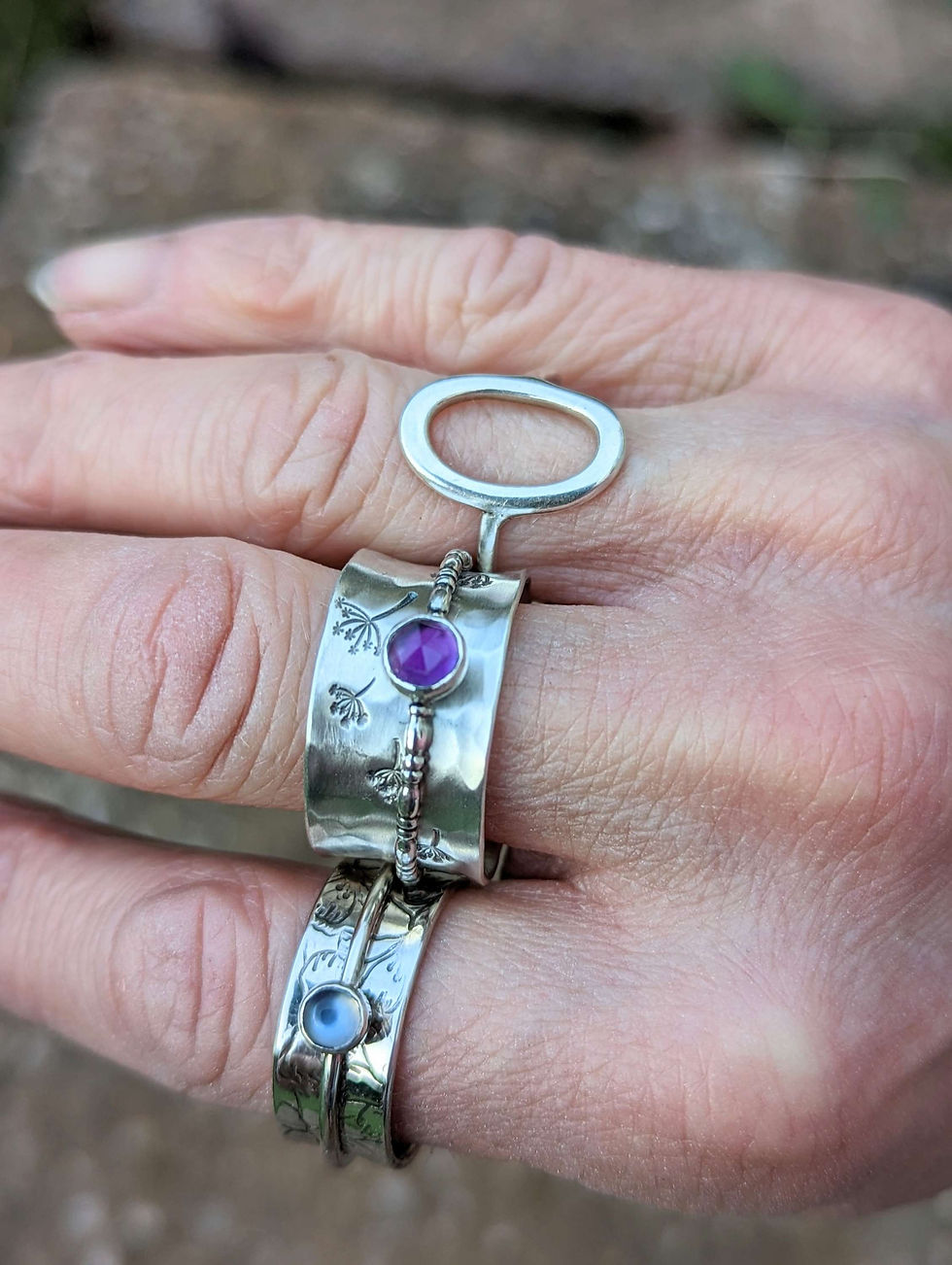 Thumbnail: A very gorgeous wide ring stamped with Dandelions with an Amethyst Spinner.