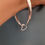 Thumbnail: Simple, elegant and very weighty silver bangle with a beaded heart charm. 