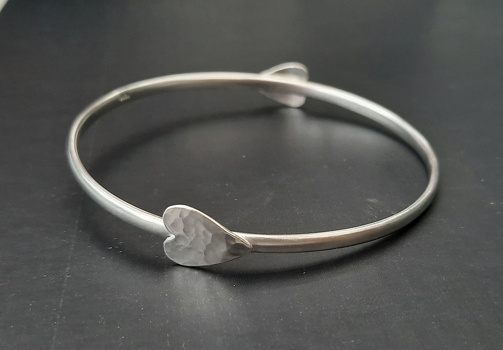 Thumbnail: Bangle with a small hammered heart on opposing sides