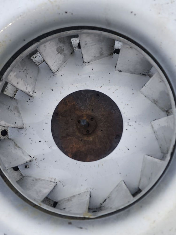 Clean fan blades on an upblast exhaust fan