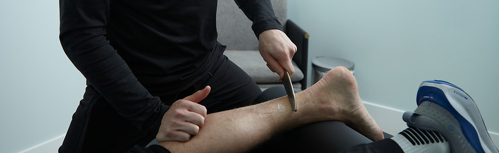 Therapist performing sports massage on an athlete’s calf muscle for recovery