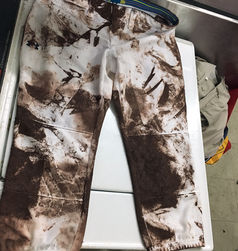 white pants covered in mud