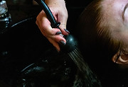 True Colors employee washes a client's hair