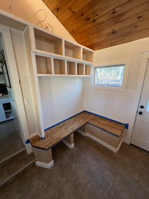 Custom-built wood foyer storage and seating area created by Elite Renovation LLC Rhode Island