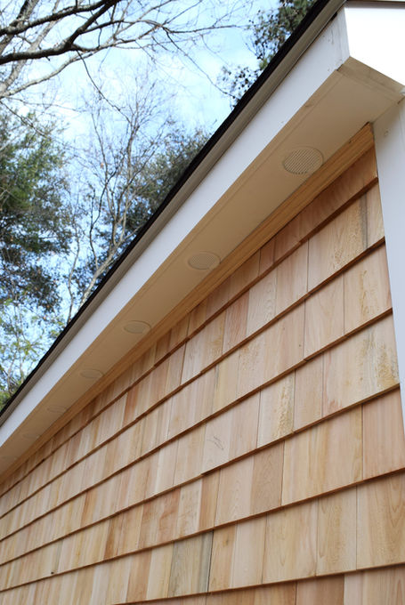 A detail shot of the roof vents built into the soffits of a cedar shake shed, built by Elite Renovation LLC Rhode Island