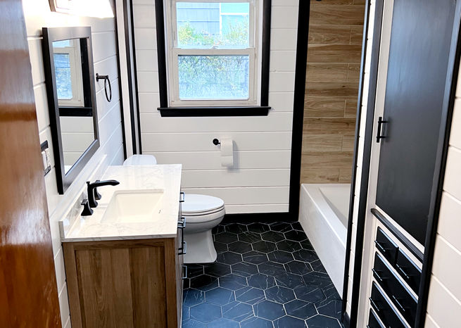 A bold high contrast bathroom remodel by Elite Renovation LLC Rhode Island