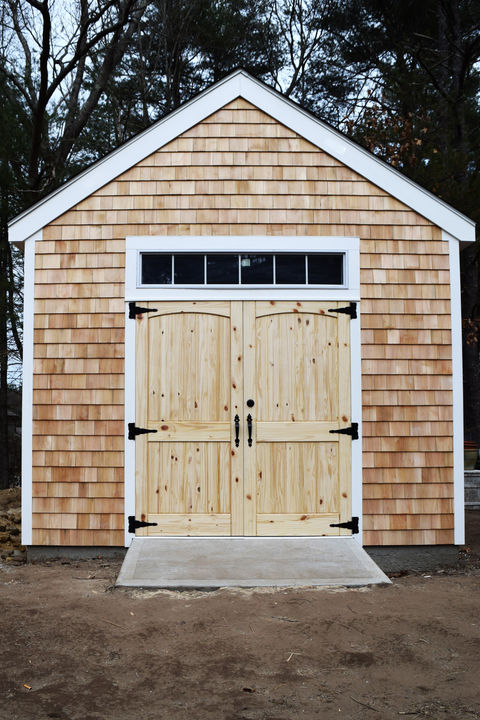 A custom shed clad in cedar shake shingles