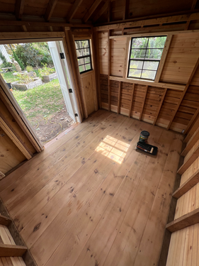 The unfinished interior of a custom built wooden shed by Elite Renovation LLC Rhode Island