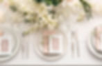 Stylish table setting with wedding invitations and gypsophila flowers, top view.jpg