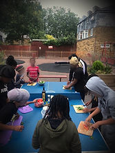 young people cooking outdoors