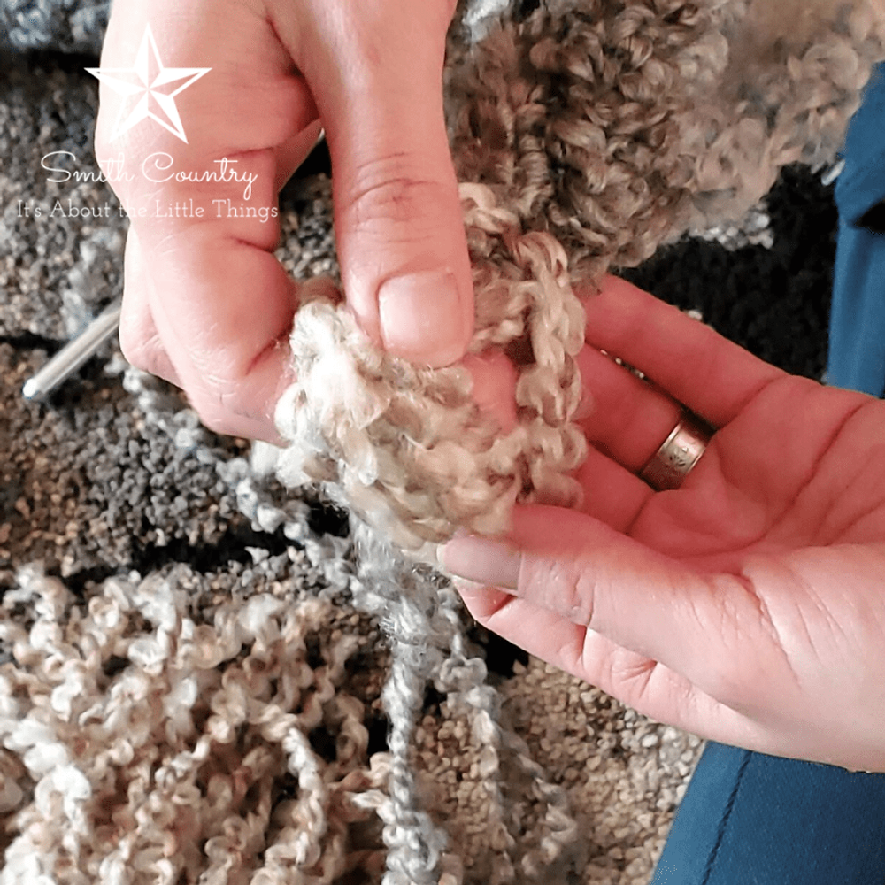Tying the yarn into a knot.