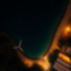 Overhead cinematic shot of St. Vincent's renewable energy, long exposure capturing light t