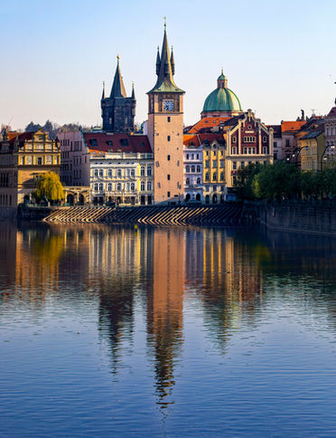 Clock tower over Vltava River in Prague