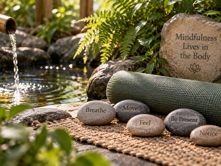 Mindfulness setting with flowing water, greenery, a meditation mat and stones representing breathing, movement, feeling, noticing and present-moment awareness.