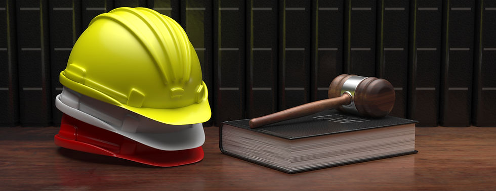 Yellow, white, and red hard hats stacked together with a gavel on a black legal book titled "Law" in front of dark bookshelves.