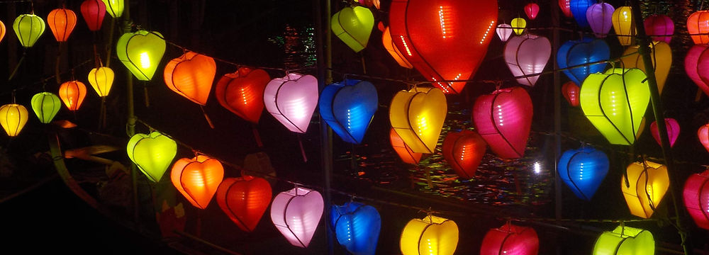 Heart-shaped lanterns glowing on a boat at night