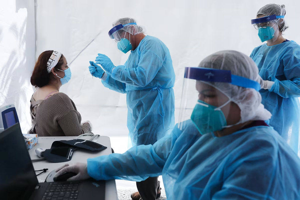 Workers test a woman for Covid-19 in Los Angeles in July 2020.