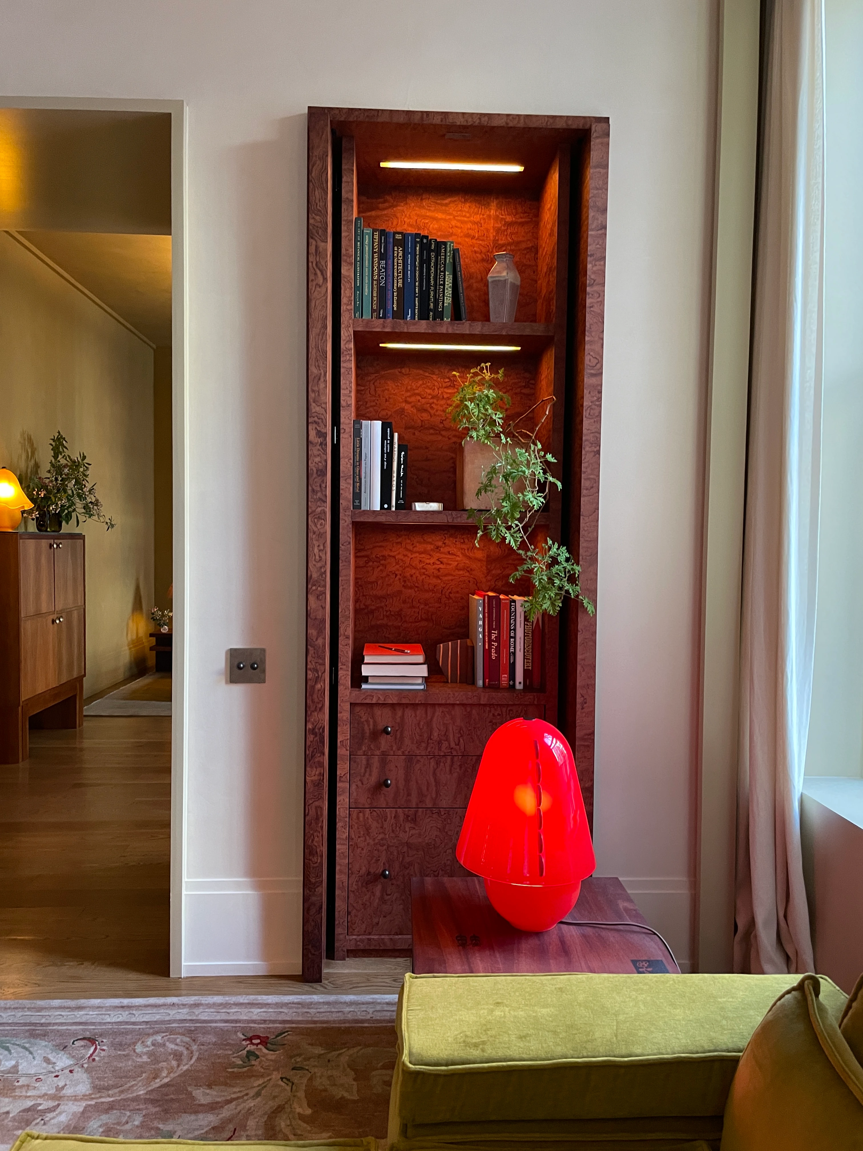 Customized beautifully grained wood shelving, and lighting in the nooks