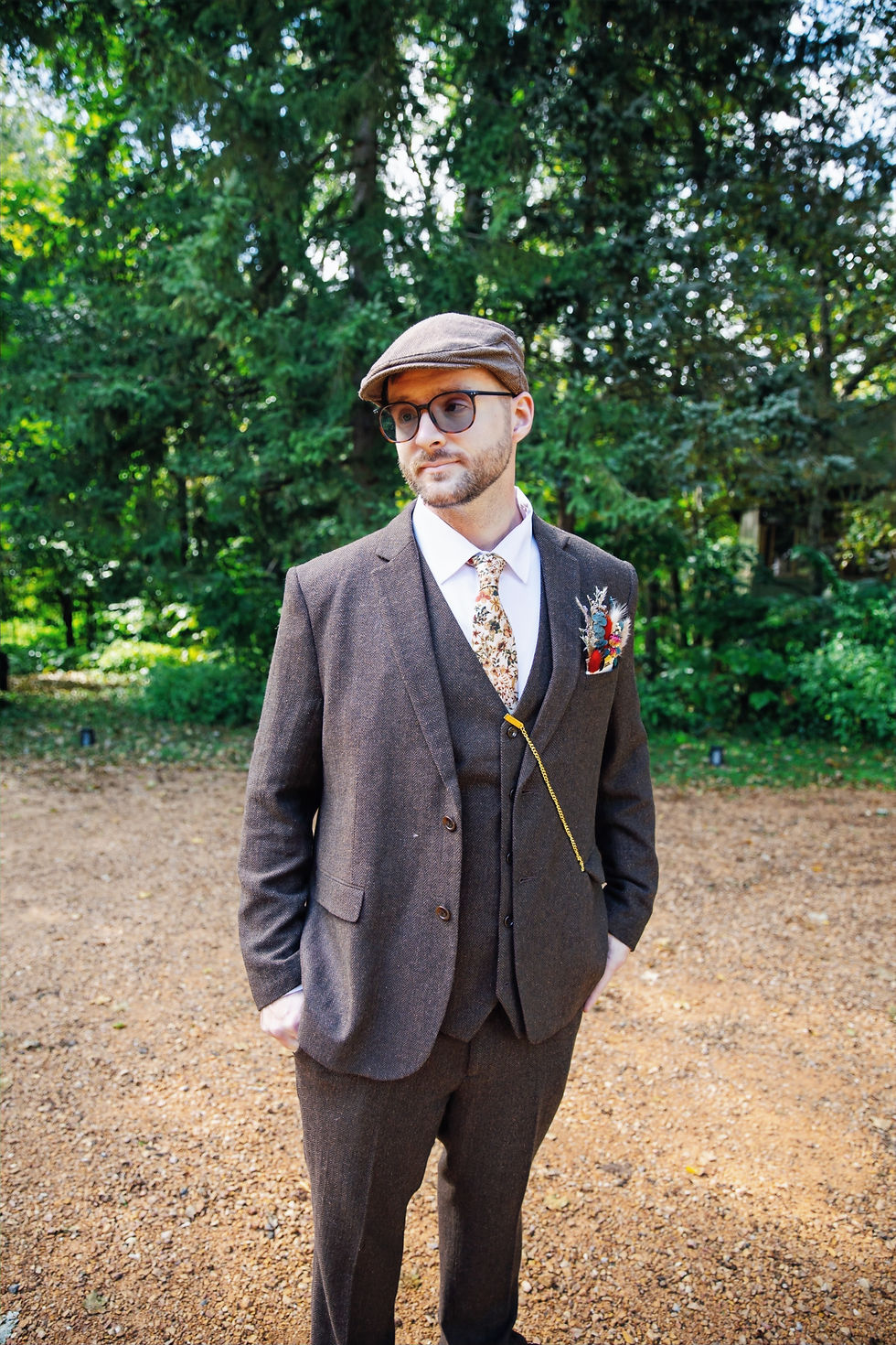 Meet The Team: Man in suit, flat cap, sunglasses
