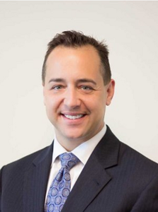Smiling man in a suit and patterned tie