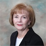 Portrait of a female team member with short blonde hair.