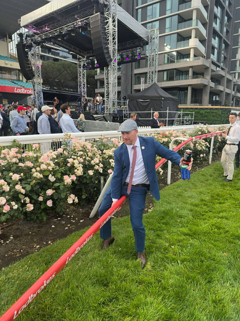 A racegoer rips off a railing at The Valley (Image: Rhett Black)