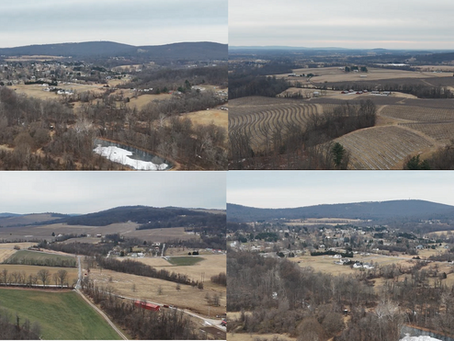 Aerial drone view of open land and surrounding properties, showing landscape and area layout for real estate and development planning