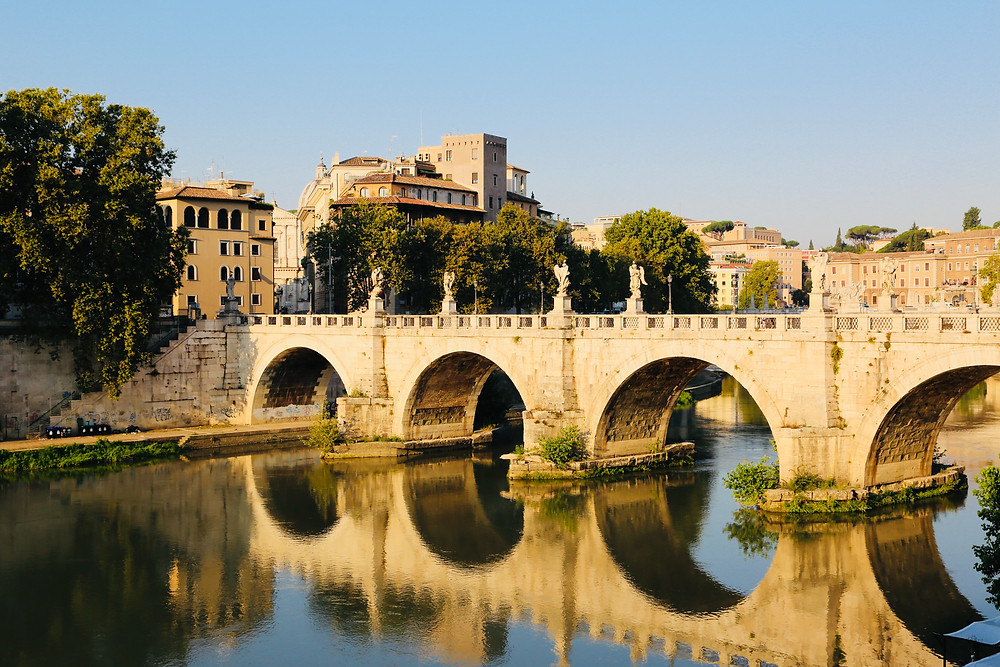 Beautiful roman bridge over the Tiber in Rome at sunrise
