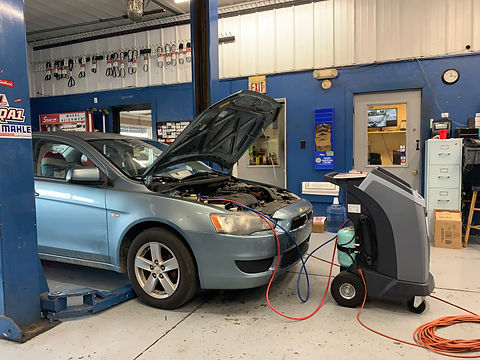 A/C freon equipment performing a service on a car in the shop at WG Baker and Son.