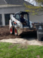 Facilities Attendant Steven Kurz on the Bobcat
